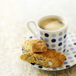 Italian espresso in spotty blue cup with cantuccini biscuits