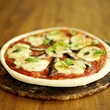Freshly cooked pizza sitting on a pizza stone