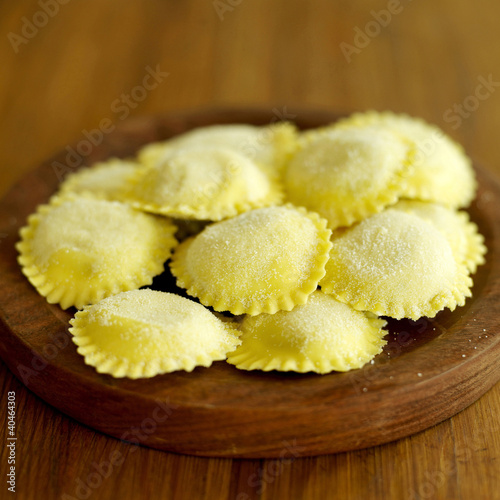 Photo: Fresh tortellini pasta on wooden board Fresh tortellini pasta on wooden board
