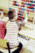 Boy and girl playing with big abacus