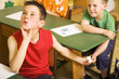 Boys passing note under the table