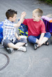 Boys holding hands while sitting together