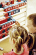 Boy and girl playing with a big abacus