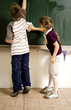 Boy and girl washing the blackboard