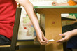 Children passing note under the table