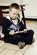 Boy sitting on the floor drawing
