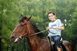 Boy riding a horse