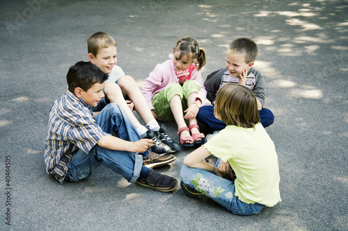 Photo: Children sitting in a circle playing Children sitting in a circle playing