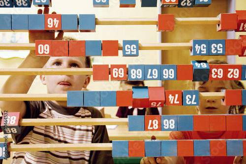 Photo: Boy and girl playing with a big abacus Boy and girl playing with a big abacus