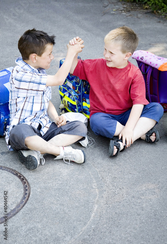 Photo: Boys holding hands while sitting together Boys holding hands while sitting together