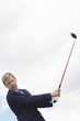 Businessman playing golf