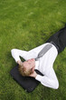 Businessman lying on the grass