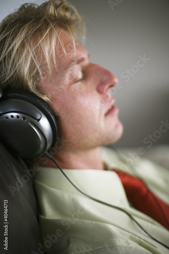 Photo: Businessman with headphone taking a nap Businessman with headphone taking a nap