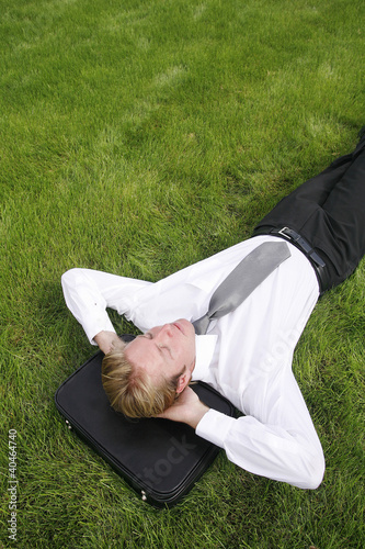 Photo: Businessman lying on the grass Businessman lying on the grass