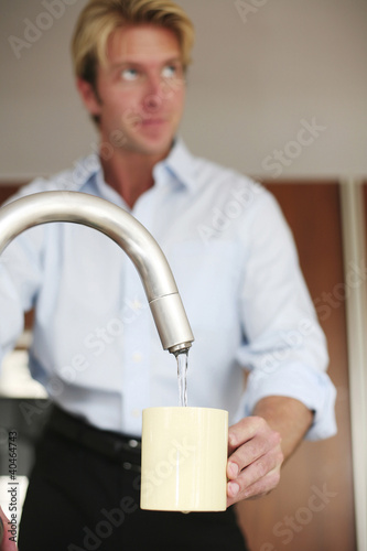 Photo: Man washing cup Man washing cup
