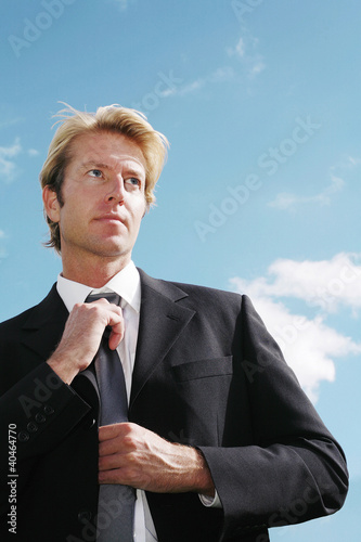 Photo: Businessman adjusting his tie Businessman adjusting his tie