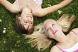 Two girls lying on the grass