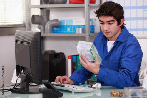 Photo: Worker looking at a building part Worker looking at a building part