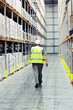 Man walking past warehouse goods