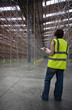 Man checking condition of warehouse
