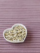 Sunflower seeds in a heart-shaped bowl