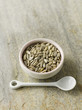 Sunflower seeds in pink bowl with white spoon