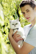 Man posing with a white cat