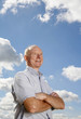 Photo: Senior man smiling while folding his arms Senior man smiling while folding his arms