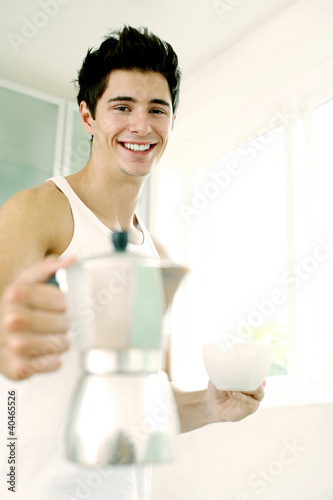 Photo: Man holding a jug and a cup Man holding a jug and a cup