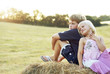 Children sitting on a haystack