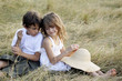 Boy and girl sitting back-to-back