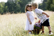 Little boy kissing little girl