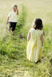 Little boy giving a strawberry to little girl
