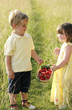 Children holding a basket of strawberries