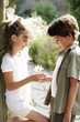 Boy giving flower to girl