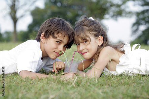 Photo: Boy and girl sharing a drink Boy and girl sharing a drink