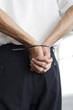 Man with hands tied to the back