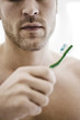 Man holding toothbrush with toothpaste