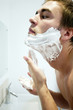 Man applying shaving cream on his face