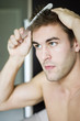 Man combing his hair