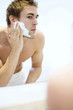 Man applying shaving cream on his face