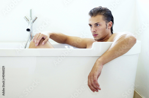 Photo: Man sitting in the bathtub Man sitting in the bathtub