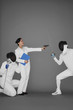 Businesswoman protecting a man by holding a gun at his opponent
