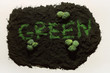 Broccoli on soil and the word 'GREEN' in the middle