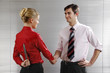 Photo: Businessman and businesswoman shaking hands, businesswoman hiding knife behind her back Businessman and businesswoman shaking hands, businesswoman hiding knife behind her back