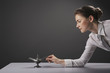 Businesswoman putting magic lamp on the table