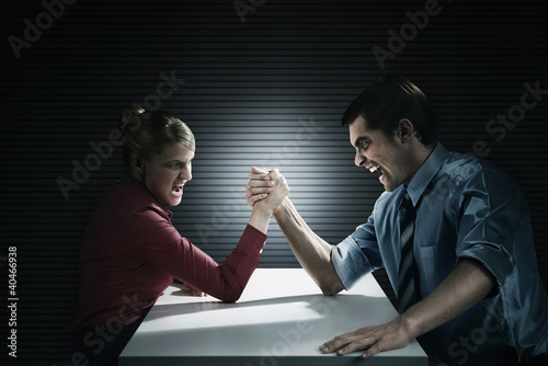 Photo: Business people arm wrestling Business people arm wrestling