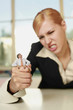 Businesswoman squeezing a tiny businessman