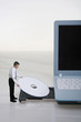 Businessman placing disc into disc drive