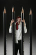 Businessman standing behind pencils